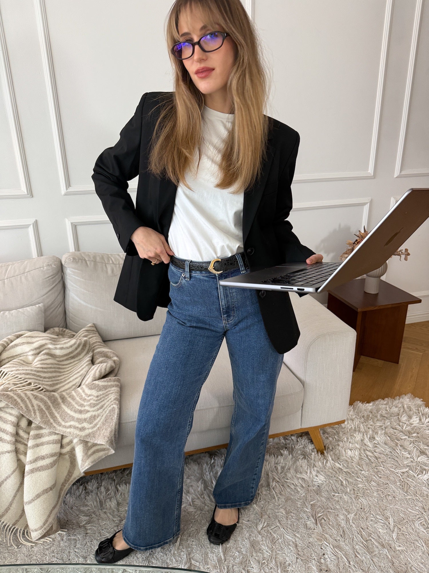 Smart casual look with a black blazer, white cotton T-shirt, and relaxed denim.